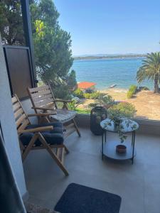 a balcony with chairs and a view of the ocean at Five shades of blue in Vourvourou