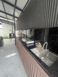 a kitchen with a sink and a counter top at Kj Resident Homestay in Alor Setar