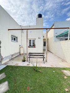 a bench sitting on a patio next to a building at Casa verde in Cañada Rosquín
