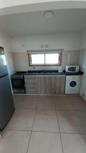 a small kitchen with a stove and a window at Juanita in Toay
