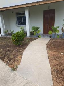 a walkway in front of a house with a door at Diamond Coast Apartment Paje in Paje