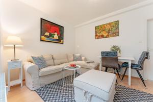 a living room with a couch and a table at Dreiseenhaus in Niederkleveez
