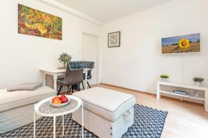 a living room with a bed and a table with a bowl of fruit at Dreiseenhaus in Niederkleveez +17 photos