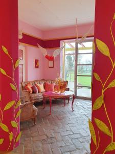 a living room with a couch and a table at Kunstgut Patapaya in Neukalen