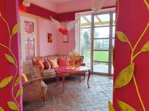 a living room with a couch and a table at Kunstgut Patapaya in Neukalen