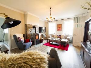 a living room with a couch and a fireplace at Ferienwohnung-Ohetal in Breddenberg