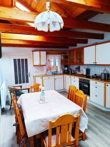 a kitchen with a table with a white table cloth on it at Ferienwohnung-Ohetal in Breddenberg