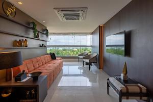 a living room with a couch and a table at Apto ALTO LUXO Atalaia - frente mar - Aracaju in Santa Maria