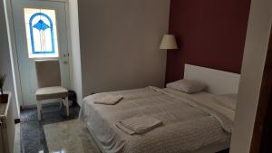 a bedroom with a bed and a window and a chair at Cozy Central Retreat in Budapest