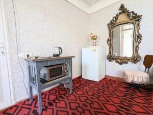 a kitchen with a microwave and a refrigerator at hotel for decent people in Tashkent