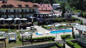 an aerial view of a resort with a pool and umbrellas at Family Hotel Eterno in Tsigov Chark +152 photos
