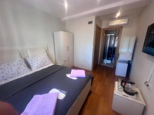 a bedroom with a large bed with purple towels on it at MYMOON Residence in Istanbul