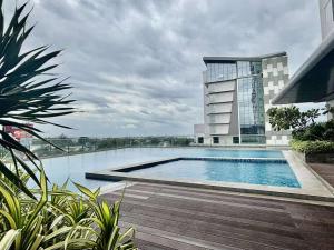 a building with a swimming pool in front of a building at Sarinas Place Sitari in Bacolod
