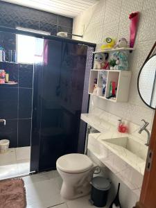 a bathroom with a shower and a toilet and a sink at Residencial Juscelino Kubitscheck in Ananindeua