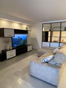 a bedroom with two beds and a large screen television at City Stay B&B in Taʼ l-Imgħajjen