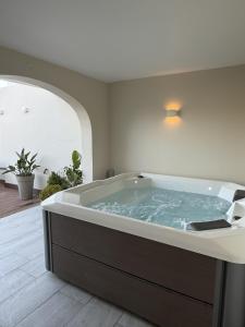 a large bath tub in a room with at City Stay B&B in Taʼ l-Imgħajjen