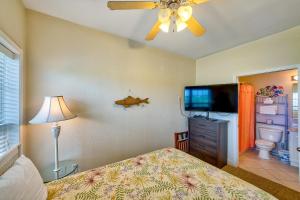 a bedroom with a bed and a flat screen tv at Gnarly Wave 351 #103DS-H in Hatteras +17 photos