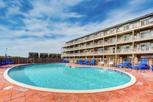a swimming pool in front of a hotel at Gnarly Wave 351 #103DS-H in Hatteras