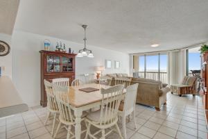 a dining room and living room with a table and chairs at Charleston Oceanfront Villas 311 in Folly Beach
