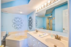a bathroom with a sink and a tub and a toilet at Charleston Oceanfront Villas 112 in Folly Beach +17 photos