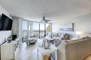 a living room with a couch and a tv at Charleston Oceanfront Villas 420 in Folly Beach