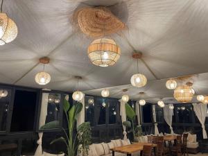 a tent with chandeliers and tables and chairs at Moorish Cabana in Fez +38 photos