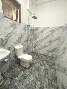 a bathroom with a toilet and a sink at Snuggle Cottage in Ella +32 photos