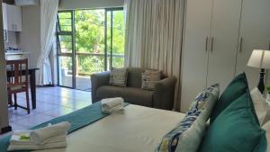 a hotel room with a bed and a living room at Suite 14- Deja' Blu Bed and Breakfast- East London in East London +58 photos