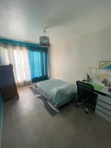 a bedroom with a bed and a desk and a desk at Occitania in Béziers