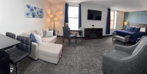 a living room with a couch and a table at The Northeastland Hotel in Presque Isle