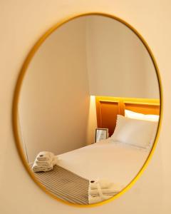 a mirror reflecting a bed in a bedroom at La Casetta di Giadapia - Apulia Houses & Flats in Ruvo di Puglia +46 photos