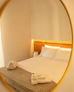 a mirror reflection of a bed in a bedroom at La Casetta di Giadapia - Apulia Houses & Flats in Ruvo di Puglia