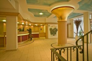 a lobby with a pillar and a counter in a building at Hotel Ochsen in Höfen an der Enz