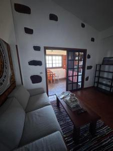 a living room with a couch and a table at Casa El Sato in Echedo
