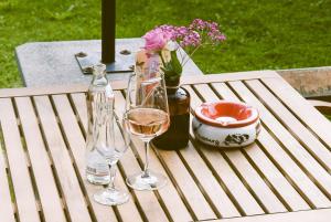 a table with two glasses of wine and flowers on it at Salzburger Dolomitenhof in Annaberg im Lammertal