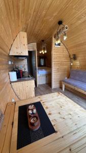 a kitchen in a wooden cabin with a table with donuts on it at Bungalows Tea Žabljak in Žabljak +17 photos