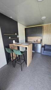 a kitchen with a desk and chairs in a room at Vila Mia 3, camp Limoni in Sukošan