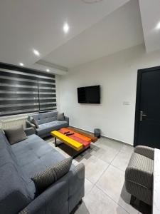 a living room with two couches and a tv at Espark baglar 1+1+ teraslı daire in Eskisehir