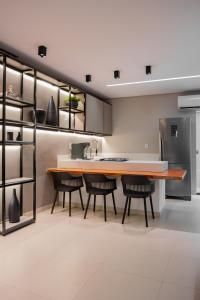 a kitchen with a large wooden table and chairs at Vila Piá 02 in Piaçabuçu +14 photos