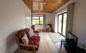 a living room with a red couch and chairs at Wild Haven apartment in Wicklow