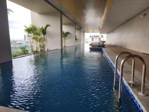 a swimming pool with blue water in a building at Hạ Long Homestay ICON40 in Ha Long