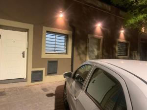 a car parked in front of a house with a white door at Aqui es 6! in Banfield
