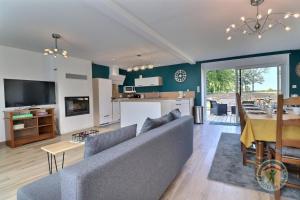 a living room and kitchen with a couch and a table at Breizh roch in Maen Roch