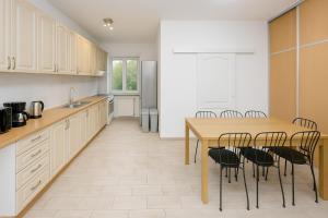 a kitchen with a wooden table and chairs at Nawat in Warsaw +29 photos