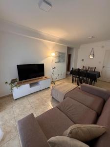 a living room with a couch and a flat screen tv at Patagonia 37 in Neuquén