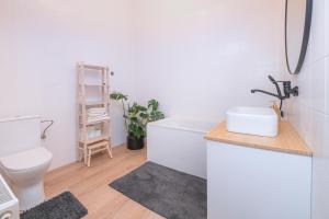 a bathroom with a sink and a toilet at KUKI Apartments in Trenčín +37 photos
