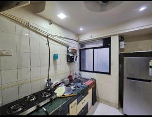 a small kitchen with a sink and a stove at Private Room At Ghodbunder Road Ovale Naka Thane West in Mire +1 photo
