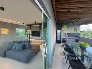 a living room with a couch and a table at Vila Piá 02 in Piaçabuçu