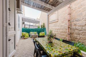 an outdoor patio with a table and chairs at Casa Mea in Balestrate