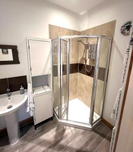 a bathroom with a shower and a sink at Cromer Getaway luxury apartment in Cromer